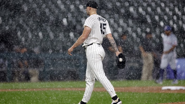 Aug 27, 2024; Chicago, Illinois, USA; Chicago White Sox starting pitcher Garrett Crochet (45) walks off the field during heavy rain in the first inning of a baseball game between the Chicago White Sox and Texas Rangers at Guaranteed Rate Field. Mandatory Credit: Kamil Krzaczynski-USA TODAY Sports