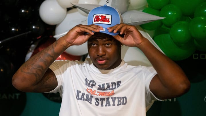 Kamarion Franklin, the No. 1 recruit in Mississippi, puts on an Ole Miss hat as he announces his commitment to Ole Miss football while wearing a shirt that says       Sip Made Kam Stayed    with the Ole Miss logo at Lake Cormorant High School in Lake Cormorant, Miss, on Saturday, August 19, 2023.