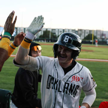 Oakland Ballers teammates high five in celebration