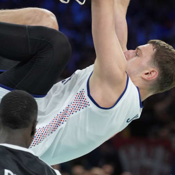 Aug 3, 2024; Villeneuve-d'Ascq, France; Serbia power forward Nikola Jovic (5) dunks against South Sudan power forward Majok Deng (13) in the third quarter during the Paris 2024 Olympic Summer Games at Stade Pierre-Mauroy. Mandatory Credit: John David Mercer-USA TODAY Sports