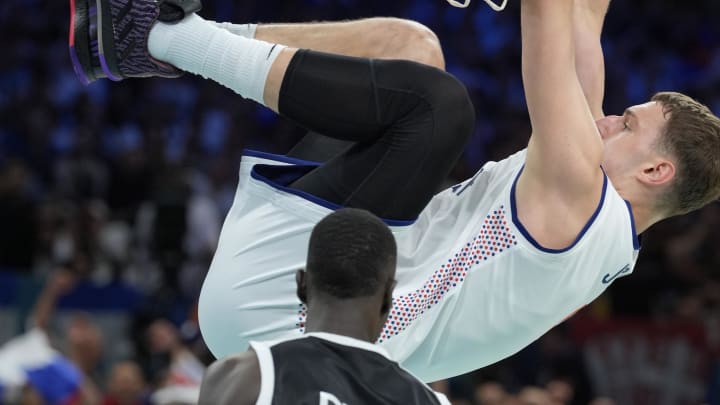 Aug 3, 2024; Villeneuve-d'Ascq, France; Serbia power forward Nikola Jovic (5) dunks against South Sudan power forward Majok Deng (13) in the third quarter during the Paris 2024 Olympic Summer Games at Stade Pierre-Mauroy. Mandatory Credit: John David Mercer-USA TODAY Sports