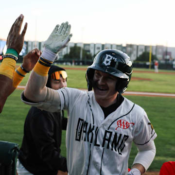 Oakland Ballers teammates high five in celebration