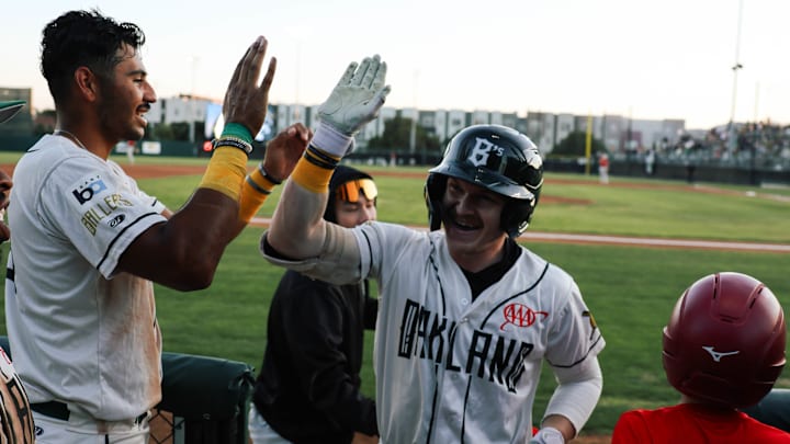 Oakland Ballers teammates high five in celebration