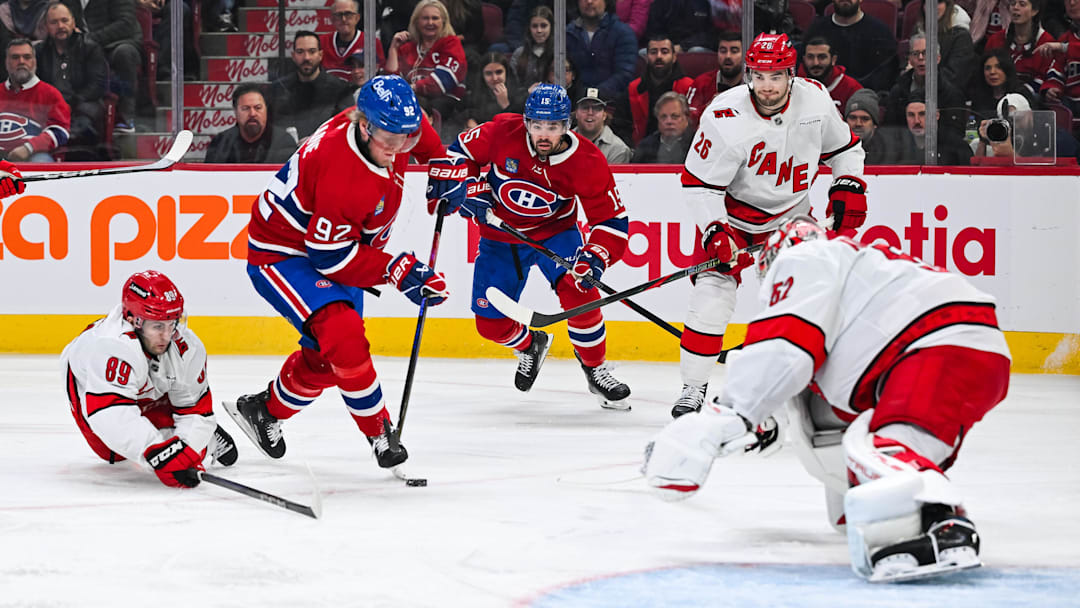 Apr 16, 2025; Montreal, Quebec, CAN; Montreal Canadiens right wing Patrik Laine (92) plays the puck against Carolina Hurricanes defenseman Domenick Fensore (89) in the first period at Bell Centre. Mandatory Credit: David Kirouac-Imagn Images