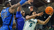 Jan 30, 2025; New Orleans, Louisiana, USA;  Tulane Green Wave guard Mari Jordan (5) drives to the basket against Memphis Tigers center Moussa Cisse (32) during the second half at Avron B. Fogelman Arena in Devlin Fieldhouse.