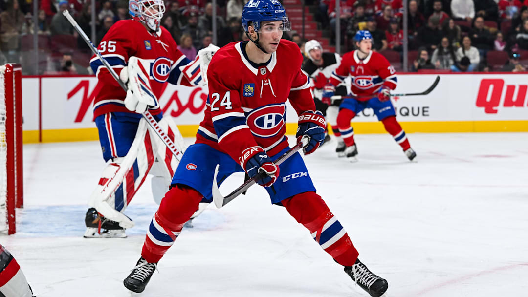 Feb 8, 2025; Montreal, Quebec, CAN; Montreal Canadiens defenseman Logan Mailloux (24) defends against the New Jersey Devils during the first period at Bell Centre. Mandatory Credit: David Kirouac-Imagn Images
