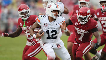 Oct 25, 2025; Fayetteville, Arkansas, USA; Auburn Tigers quarterback Ashton Daniels (14) rushes during the third quarter against the Arkansas Razorbacks at Donald W. Reynolds Razorback Stadium. Mandatory Credit: Nelson Chenault-Imagn Images