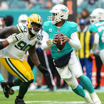 Miami Dolphins quarterback Tua Tagovailoa (1) drops back before attempting a pass against the Green Bay Packers during the first half at Hard Rock Stadium on Christmas Day 2022.