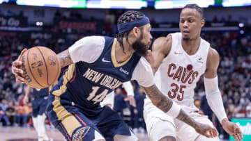 Mar 13, 2024; New Orleans, Louisiana, USA; New Orleans Pelicans forward Brandon Ingram (14) dribbles against Cleveland Cavaliers forward Isaac Okoro (35) during the second half at Smoothie King Center.