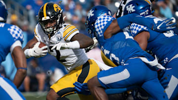 Iowa running back Kaleb Johnson (2) rushes past Kentucky defenders during the first quarter of the TransPerfect Music City Bowl, Saturday, Dec. 31, 2022, at Nissan Stadium in Nashville, Tenn.