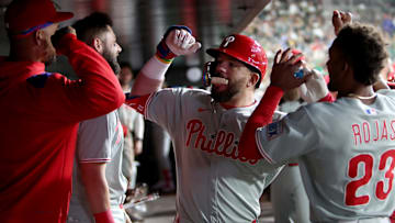 May 24, 2025; West Sacramento, California, USA; Philadelphia Phillies designated hitter Kyle Schwarber (12) is congratulated by teammates in the dugout after hitting a solo home run against the Athletics during the sixth inning at Sutter Health Park.