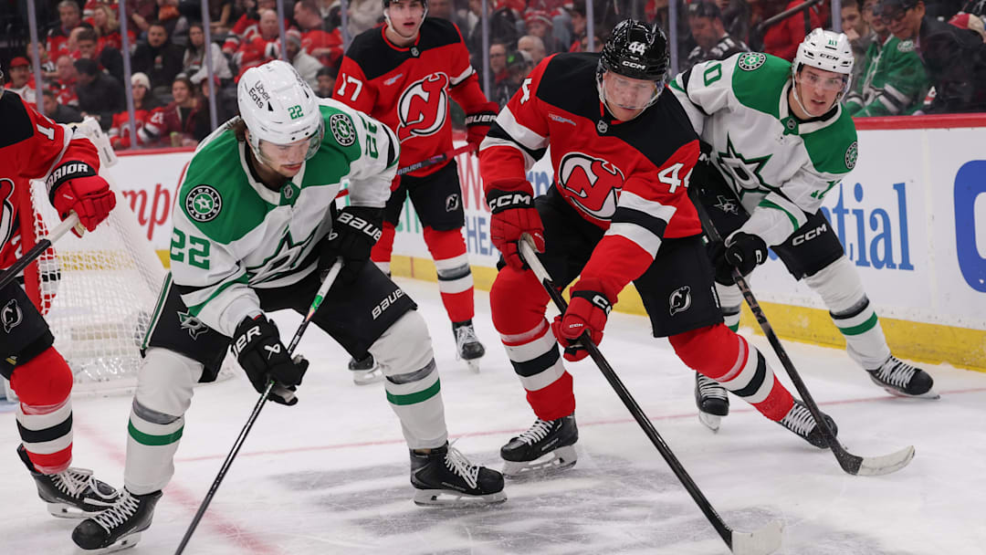Dec 3, 2025; Newark, New Jersey, USA; New Jersey Devils defenseman Dennis Cholowski (44) plays the puck away from Dallas Stars center Mavrik Bourque (22) during the first period at Prudential Center. Mandatory Credit: Ed Mulholland-Imagn Images