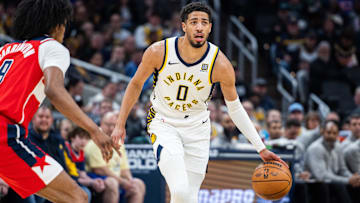 Apr 8, 2025; Indianapolis, Indiana, USA; Indiana Pacers guard Tyrese Haliburton (0) dribbles the ball while Washington Wizards forward Justin Champagnie (9) defends in the first half at Gainbridge Fieldhouse. Mandatory Credit: Trevor Ruszkowski-Imagn Images