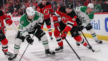Dec 3, 2025; Newark, New Jersey, USA; New Jersey Devils defenseman Dennis Cholowski (44) plays the puck away from Dallas Stars center Mavrik Bourque (22) during the first period at Prudential Center. Mandatory Credit: Ed Mulholland-Imagn Images