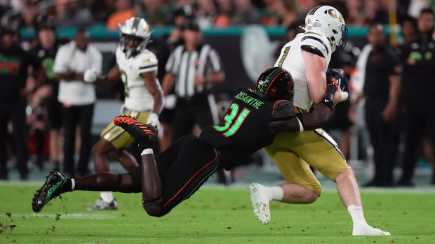 Miami Hurricanes linebacker Wesley Bissainthe (31) brings down Georgia Tech Yellow Jackets tight end Luke Benson (81) in the 