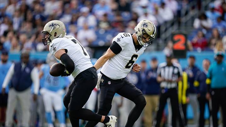 New Orleans Saints quarterback Tyler Shough (6) hands off to quarterback Taysom Hill (7) during the first quarter at Nissan Stadium in Nashville, Tenn., Sunday, Dec. 28, 2025.