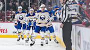 Dec 17, 2024; Montreal, Quebec, CAN; Buffalo Sabres center Dylan Cozens (24) celebrates his goal with his teammates at the bench against the Montreal Canadiens during the second period at Bell Centre. Mandatory Credit: David Kirouac-Imagn Images