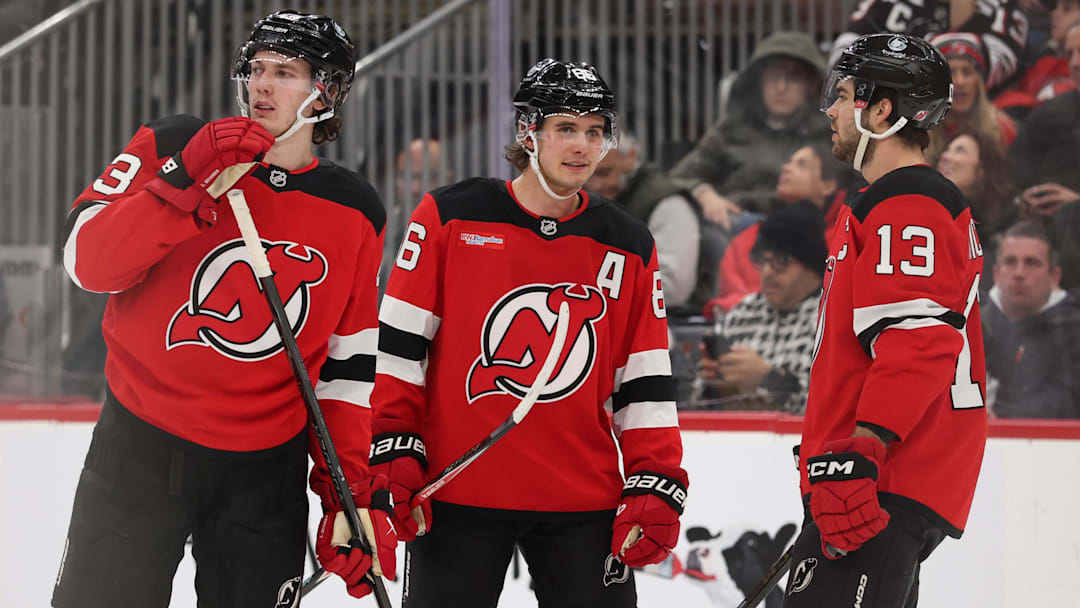 Jan 3, 2026; Newark, New Jersey, USA; New Jersey Devils defenseman Luke Hughes (43),  center Jack Hughes (86) and center Nico Hischier (13) talk during the second period of their game against the Utah Mammoth at Prudential Center. Mandatory Credit: Ed Mulholland-Imagn Images