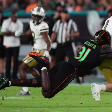 Oct 7, 2023; Miami Gardens, Florida, USA; Miami Hurricanes linebacker Wesley Bissainthe (31) brings down Georgia Tech Yellow Jackets tight end Luke Benson (81) in the first half at Hard Rock Stadium. Mandatory Credit: Jasen Vinlove-USA TODAY Sports