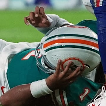 Sep 12, 2024; Miami Gardens, Florida, USA; Miami Dolphins quarterback Tua Tagovailoa (1) suffers an apparent concussion after hitting his head on the ground while being tackled by Buffalo Bills safety Damar Hamlin (3) during the second half at Hard Rock Stadium. 