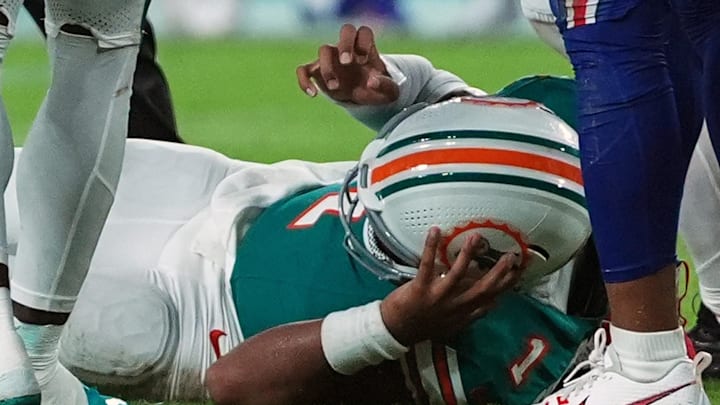 Sep 12, 2024; Miami Gardens, Florida, USA; Miami Dolphins quarterback Tua Tagovailoa (1) suffers an apparent concussion after hitting his head on the ground while being tackled by Buffalo Bills safety Damar Hamlin (3) during the second half at Hard Rock Stadium. 