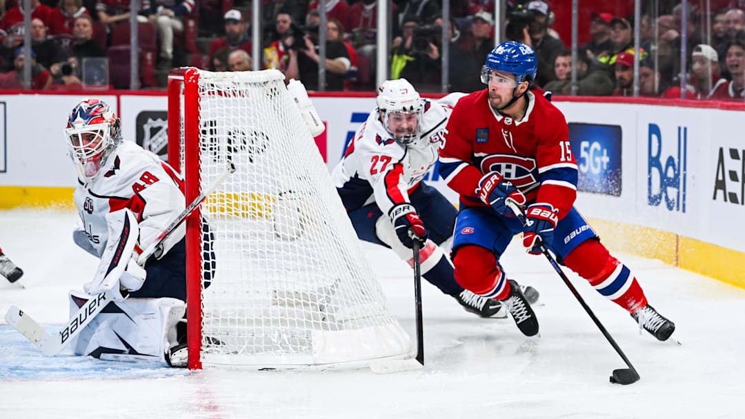 Apr 27, 2025; Montreal, Quebec, CAN; Montreal Canadiens center Alex Newhook (15) plays the puck around the net against Washington Capitals defenseman Alex Alexeyev (27) during the third period in game four of the first round of the 2025 Stanley Cup Playoffs at Bell Centre. Mandatory Credit: David Kirouac-Imagn Images