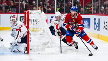 Apr 27, 2025; Montreal, Quebec, CAN; Montreal Canadiens center Alex Newhook (15) plays the puck around the net against Washington Capitals defenseman Alex Alexeyev (27) during the third period in game four of the first round of the 2025 Stanley Cup Playoffs at Bell Centre. Mandatory Credit: David Kirouac-Imagn Images