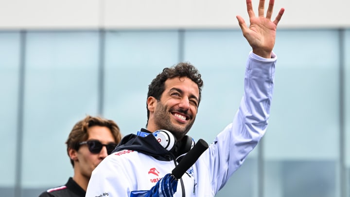 Jun 9, 2024; Montreal, Quebec, CAN; RB driver Daniel Ricciardo (AUS) salutes the crowd during the drivers parade of the Canadien Grand Prix at Circuit Gilles Villeneuve. Mandatory Credit: David Kirouac-USA TODAY Sports