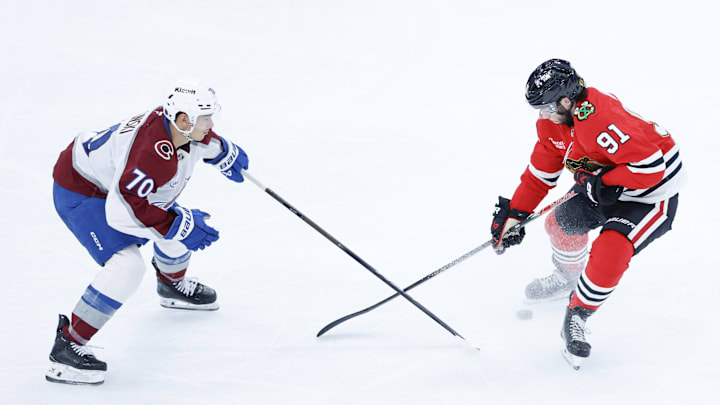 Nov 23, 2025; Chicago, Illinois, USA; Colorado Avalanche defenseman Sam Malinski (70) battle for he puck with Chicago Blackhawks center Frank Nazar (91) during the third period at United Center. Mandatory Credit: Kamil Krzaczynski-Imagn Images