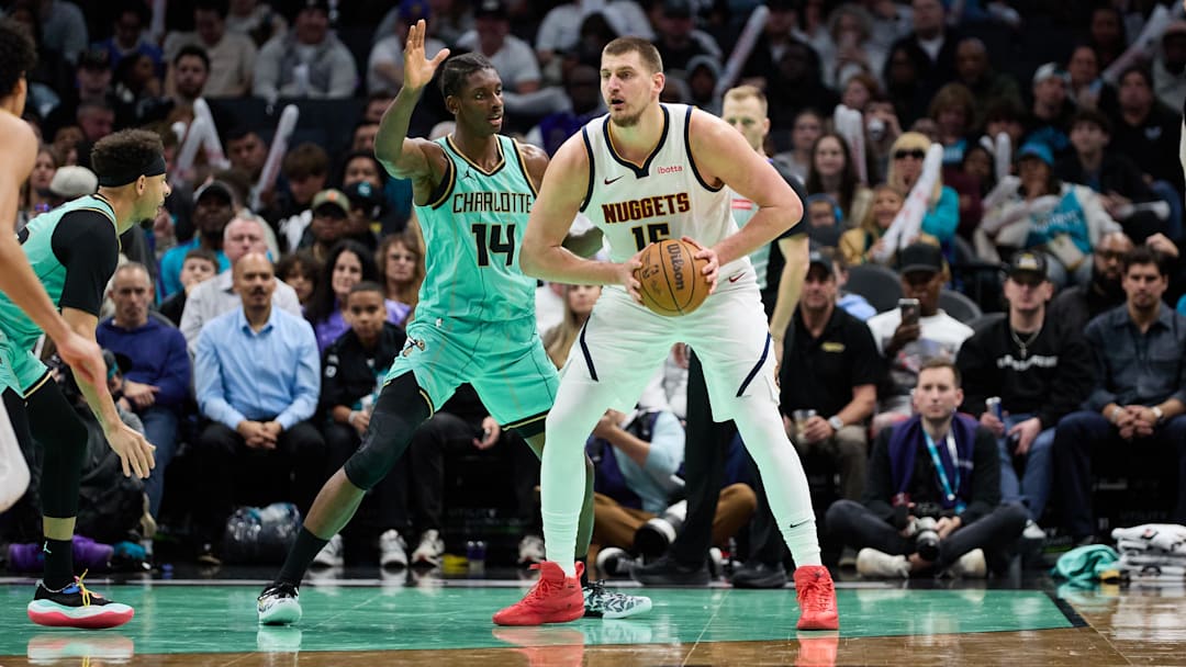 Feb 1, 2025; Charlotte, North Carolina, USA; Denver Nuggets center Nikola Jokic (15) is defended by Charlotte Hornets forward Moussa Diabate (14) during the second half of play at Spectrum Center. Mandatory Credit: Brian Westerholt-Imagn Images