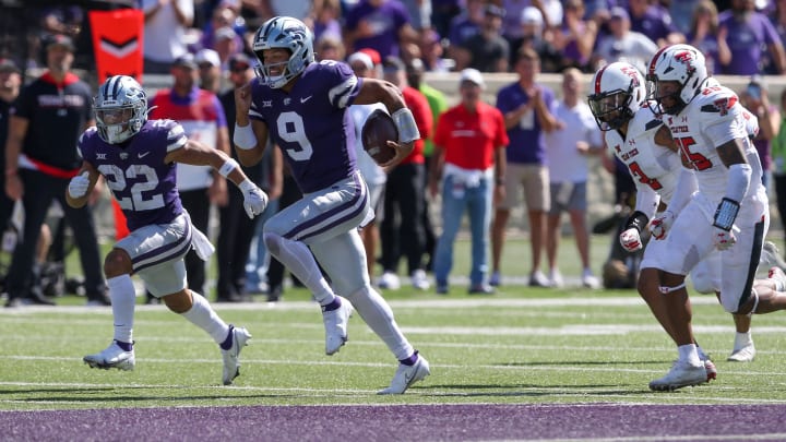 Oct 1, 2022; Manhattan, Kansas, USA; Kansas State Wildcats quarterback Adrian Martinez (9) breaks away from several Texas Tech Red Raiders defenders on his way to a touchdown in the fourth quarter at Bill Snyder Family Football Stadium. Mandatory Credit: Scott Sewell-USA TODAY Sports