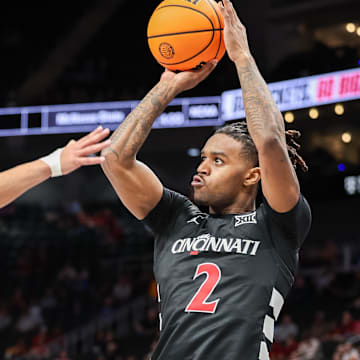 Mar 12, 2025; Kansas City, MO, USA; Cincinnati Bearcats guard Jizzle James (2) shoots the ball during the second half against the Iowa State Cyclones at T-Mobile Center. Mandatory Credit: William Purnell-Imagn Images