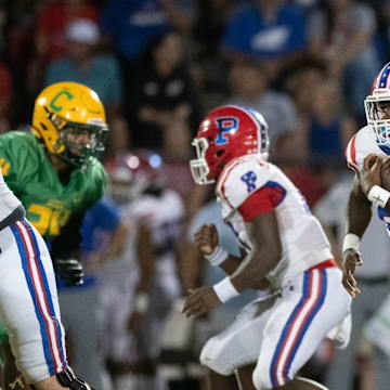 Makael Williams (20) carries the ball during the Pace vs Catholic football game at Pensacola Catholic High School on Friday, Aug. 30, 2024.