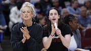 Jun 7, 2025; Chicago, Illinois, USA; Injured Indiana Fever guard Sophie Cunningham (8) and guard Caitlin Clark (22) react from the bench during the first half of a WNBA game against the Chicago Sky at United Center. Mandatory Credit: Kamil Krzaczynski-Imagn Images
