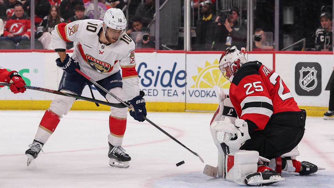 Mar 3, 2026; Newark, New Jersey, USA; New Jersey Devils goaltender Jacob Markstrom (25) makes a save on Florida Panthers left wing A.J. Greer (10) during the first period at Prudential Center. Mandatory Credit: Ed Mulholland-Imagn Images