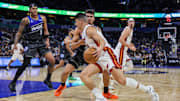 Dec 9, 2025; Orlando, Florida, USA; Miami Heat forward Simone Fontecchio (0) drives around Orlando Magic forward Tristan da Silva (23) during the second quarter at Kia Center. Mandatory Credit: Mike Watters-Imagn Images