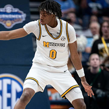 Mississippi State Bulldogs forward Cameron Matthews (4) passes while pressured by Missouri Tigers guard Anthony Robinson II (0) during their second round game of the SEC Men's Basketball Tournament at Bridgestone Arena in Nashville, Tenn., Thursday, March 13, 2025.