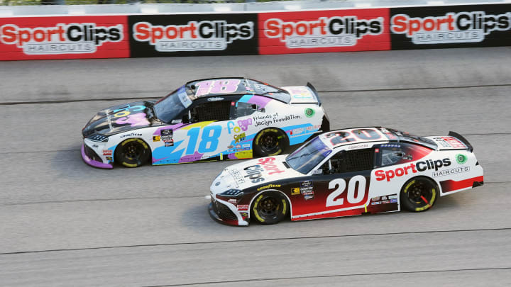 Aug 31, 2024; Darlington, South Carolina, USA; Xfinity Series driver Christopher Bell (20) races Xfinity Series driver Sheldon Creed (18) during the Sport Clips Haircuts VFW Help A Hero 200 at Darlington Raceway.