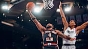 Illinois guard Kylan Boswell (4) finish at the rim against a UConn defender in the Illini's 74-61 loss to the Huskies last week at Madison Square Garden in New York City.