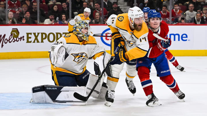 Jan 12, 2023; Montreal, Quebec, CAN; Montreal Canadiens right wing Cole Caufield (22) collides with Nashville Predators defenseman Mattias Ekholm (14) in front of goalie Yaroslav Askarov (30) while tracking the puck at eye level during the second period at Bell Centre. Mandatory Credit: David Kirouac-USA TODAY Sports