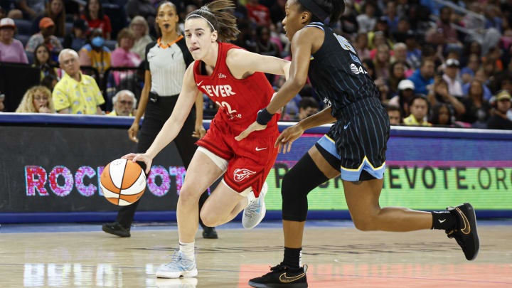 Aug 30, 2024; Chicago, Illinois, USA; Indiana Fever guard Caitlin Clark (22) drives to the basket against Chicago Sky guard Lindsay Allen (15) during the first half at Wintrust Arena. 