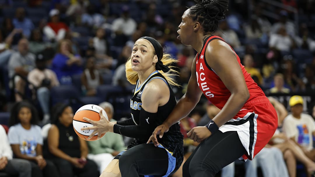 Aug 25, 2024; Chicago, Illinois, USA; Chicago Sky guard Chennedy Carter (7) drives to the basket against Las Vegas Aces guard Chelsea Gray (12) during the first half at Wintrust Arena. Mandatory Credit: Kamil Krzaczynski-Imagn Images