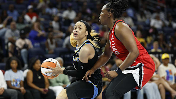 Aug 25, 2024; Chicago, Illinois, USA; Chicago Sky guard Chennedy Carter (7) drives to the basket against Las Vegas Aces guard Chelsea Gray (12) during the first half at Wintrust Arena. Mandatory Credit: Kamil Krzaczynski-Imagn Images