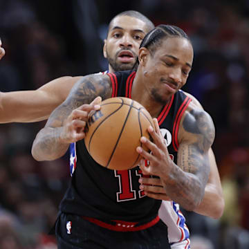 Dec 30, 2023; Chicago, Illinois, USA; Philadelphia 76ers forward Nicolas Batum (40) defends against Chicago Bulls forward DeMar DeRozan (11) during the second half at United Center. Mandatory Credit: Kamil Krzaczynski-Imagn Images