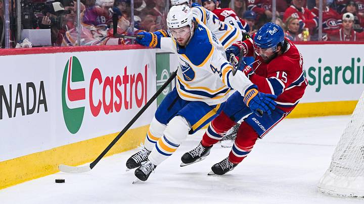 May 16, 2026; Montreal, Quebec, CAN; Buffalo Sabres defenseman Bowen Byram (4) defends the puck against Montreal Canadiens center Alex Newhook (15) during the third period in game six of the second round of the 2026 Stanley Cup Playoffs at Bell Centre. Mandatory Credit: David Kirouac-Imagn Images
