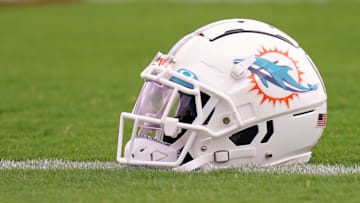 Jul 27, 2022; Miami Gardens, FL, USA; A general view of a Miami Dolphins helmet on the field during training camp at Baptist Health Training Complex. Mandatory Credit: Jasen Vinlove-Imagn Images