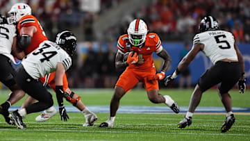 Dec 28, 2024; Orlando, FL, USA; Miami Hurricanes running back Mark Fletcher Jr. (4) runs the ball against the Iowa State Cyclones during the second half at Camping World Stadium. Mandatory Credit: Jasen Vinlove-Imagn Images