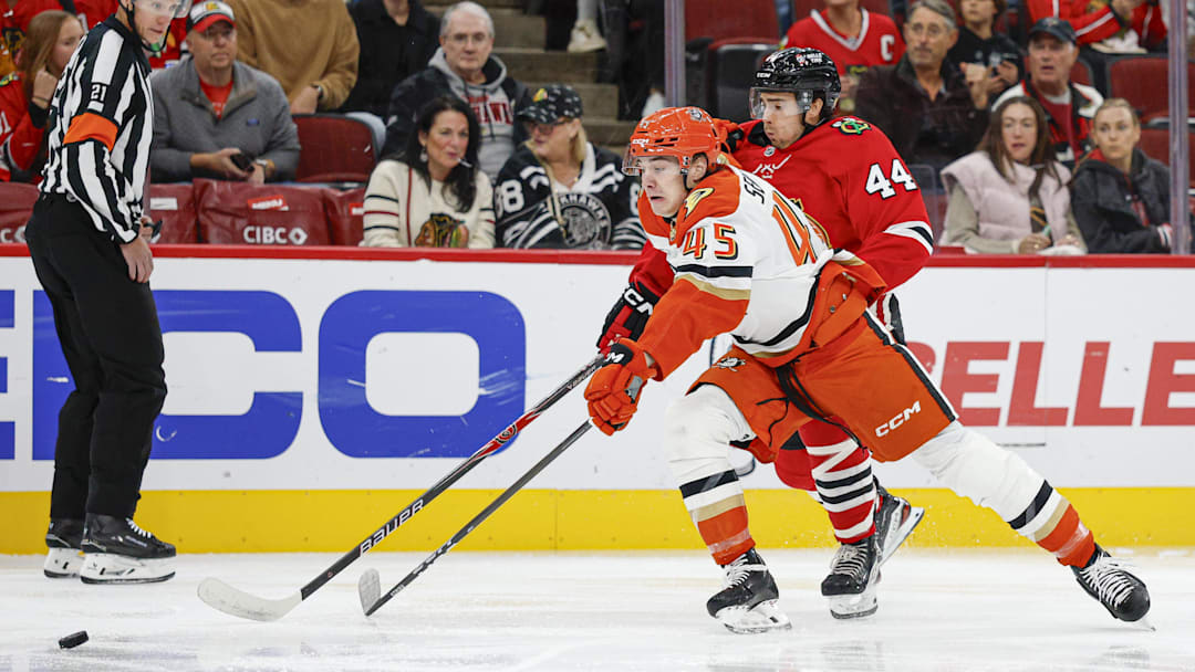 Oct 19, 2025; Chicago, Illinois, USA; Chicago Blackhawks defenseman Wyatt Kaiser (44) defends against Anaheim Ducks right wing Beckett Sennecke (45) during the first period at United Center. Mandatory Credit: Kamil Krzaczynski-Imagn Images
