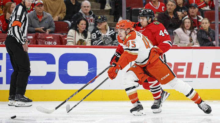 Oct 19, 2025; Chicago, Illinois, USA; Chicago Blackhawks defenseman Wyatt Kaiser (44) defends against Anaheim Ducks right wing Beckett Sennecke (45) during the first period at United Center. Mandatory Credit: Kamil Krzaczynski-Imagn Images