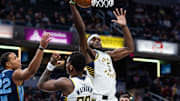 Oct 14, 2024; Indianapolis, Indiana, USA; Indiana Pacers forward Jarace Walker (5) rebounds the ball while Memphis Grizzlies guard Desmond Bane (22) defends in the first quarter at Gainbridge Fieldhouse. Mandatory Credit: Trevor Ruszkowski-Imagn Images
